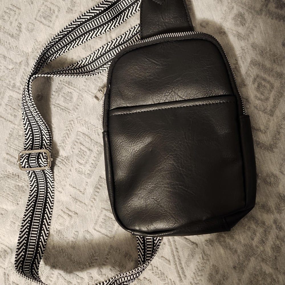 Purse, new cross body sling black and white adjustable strap.